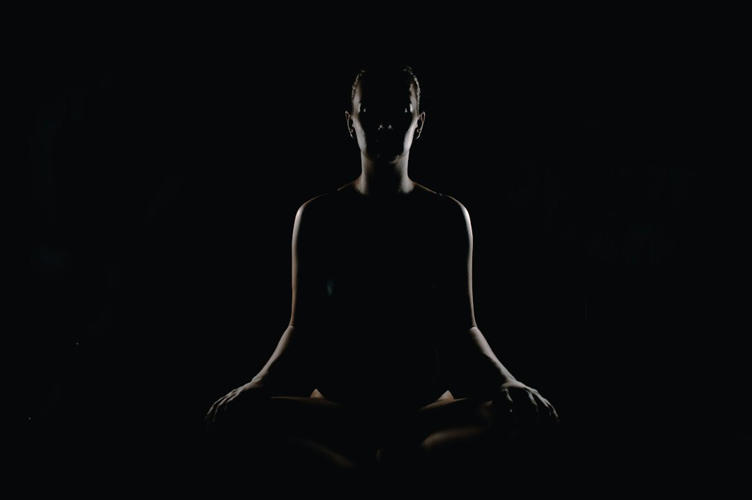 person meditating in nature